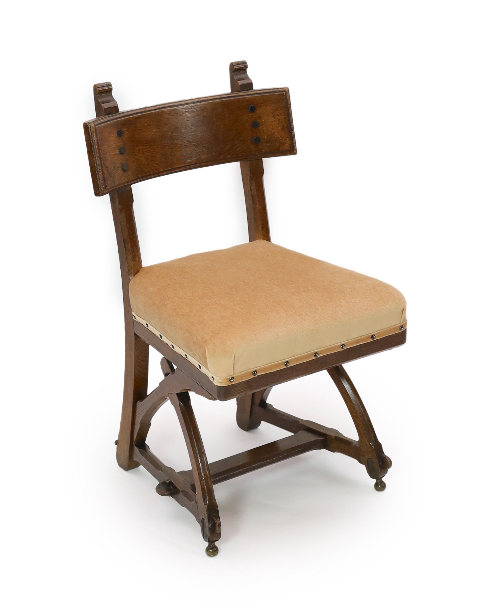 A Victorian reformed gothic oak dining chair designed by Edward Welby Pugin, c.1864, W. 50cm. D. 48cm. H. 84cm.
